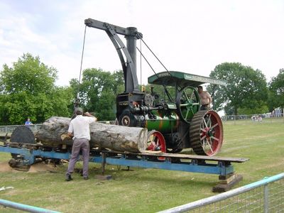 Working traction engines sawing logs
