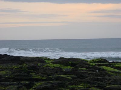 Waves break on the shore at Tanah Lot
