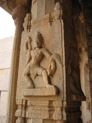 Dancer  on Carved pillar, temple in Hampi.
