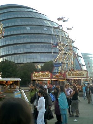 Greater London Authority building and funfair by Tower Bridge
