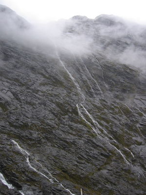 Waterfalls in mountains on road from Milford Sound to Te Anau
